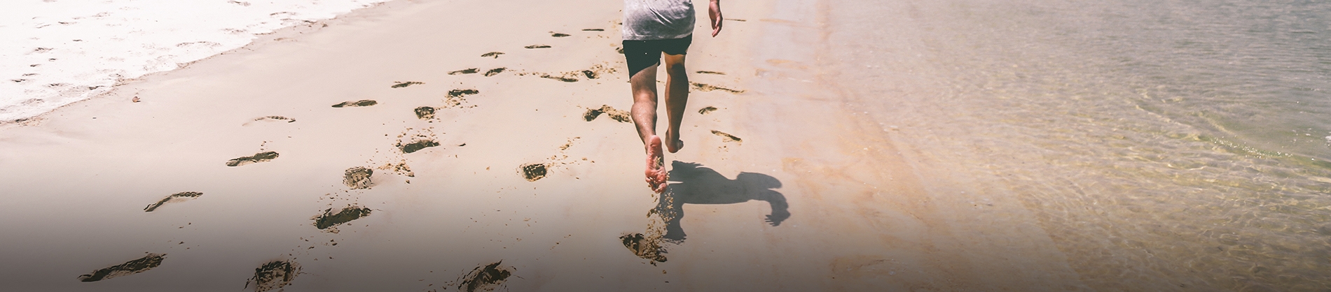A man running along a beach A man running along a beach