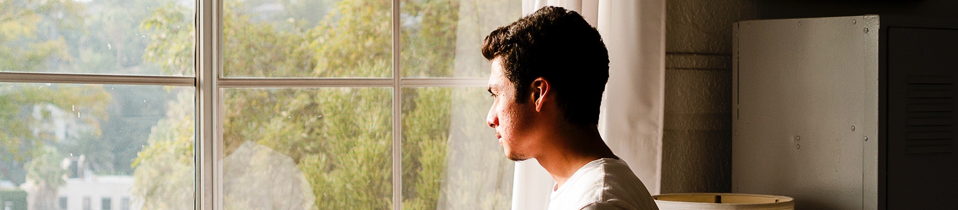 A man looking out of a window A man looking out of a window