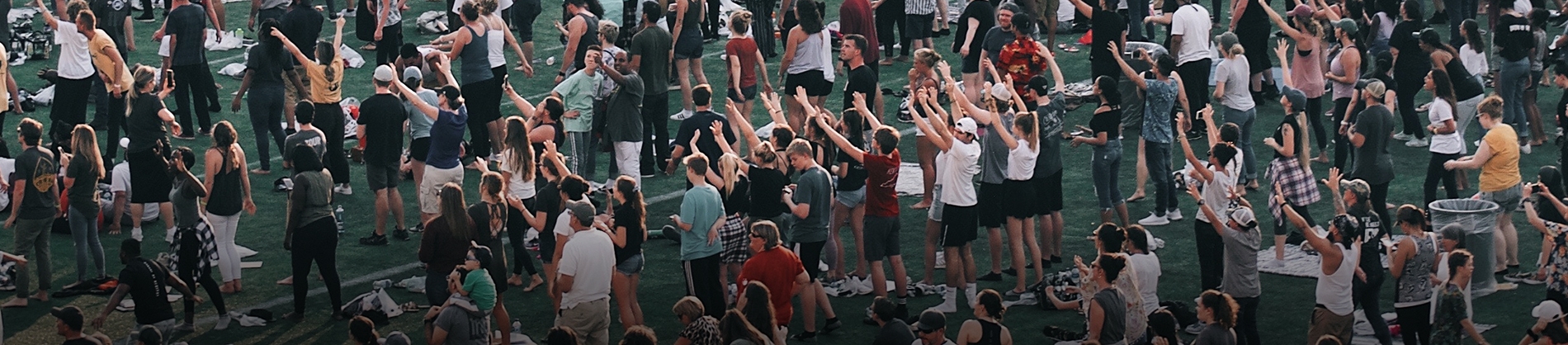 A crowd of people with their arms up in the air A crowd of people with their arms up in the air