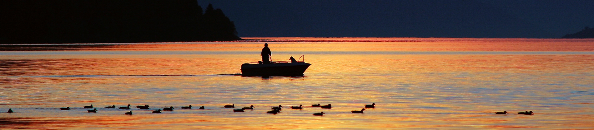 A man fishing on a boat in the ocean A man fishing on a boat in the ocean