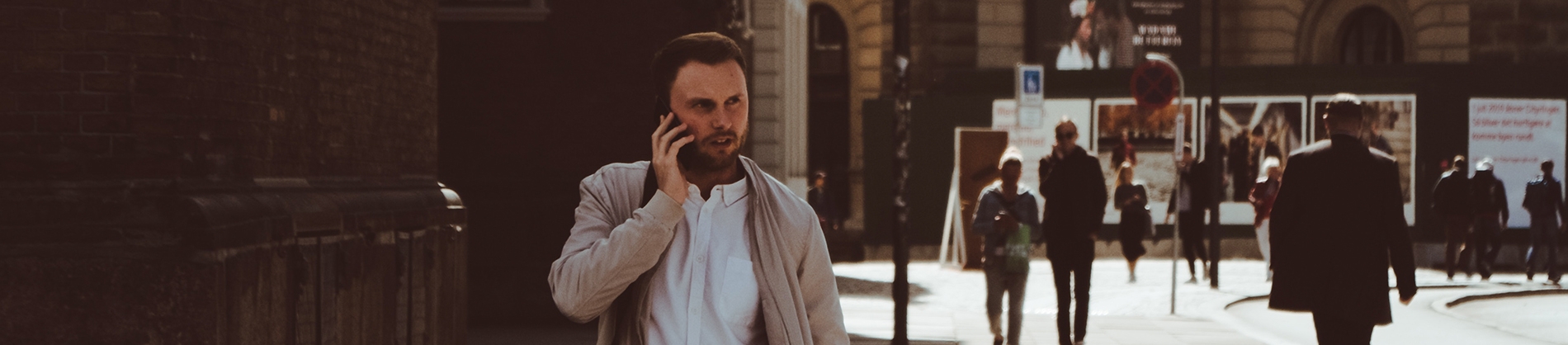 A man walking down the street on his phone A man walking down the street on his phone