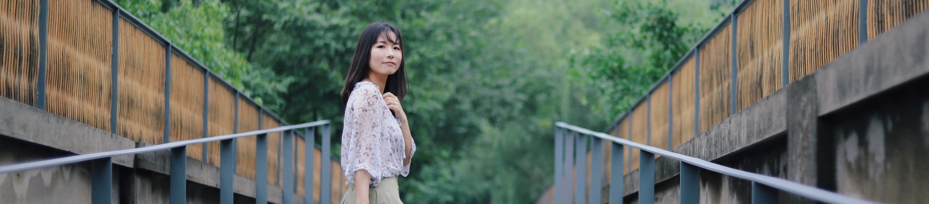 A women walking up a path looking behind her A women walking up a path looking behind her