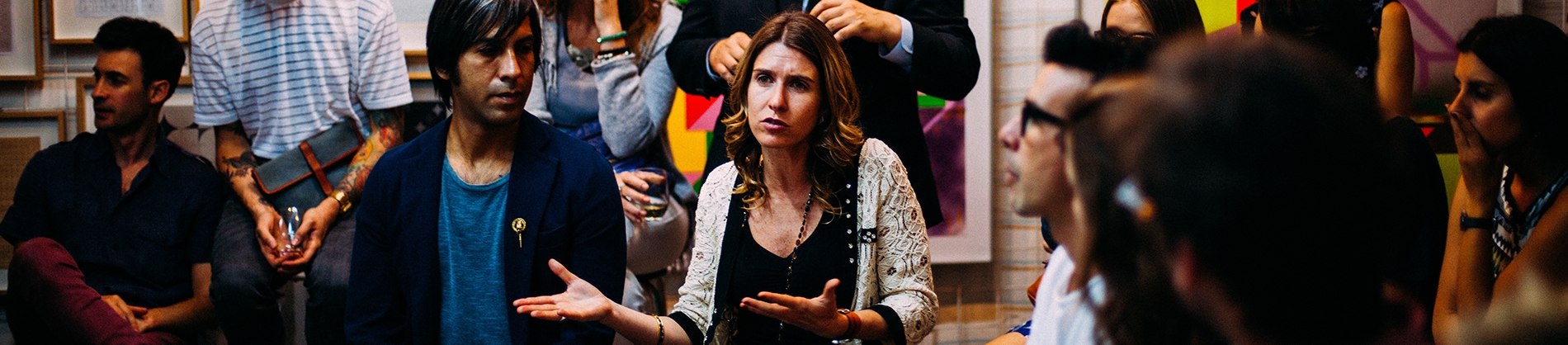 A women sat down talking to a group of people