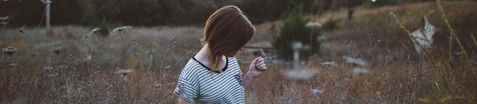 Girl walking through a field