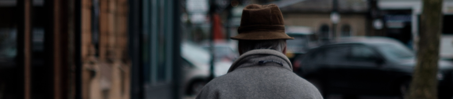 A elderly man walking down the street A elderly man walking down the street
