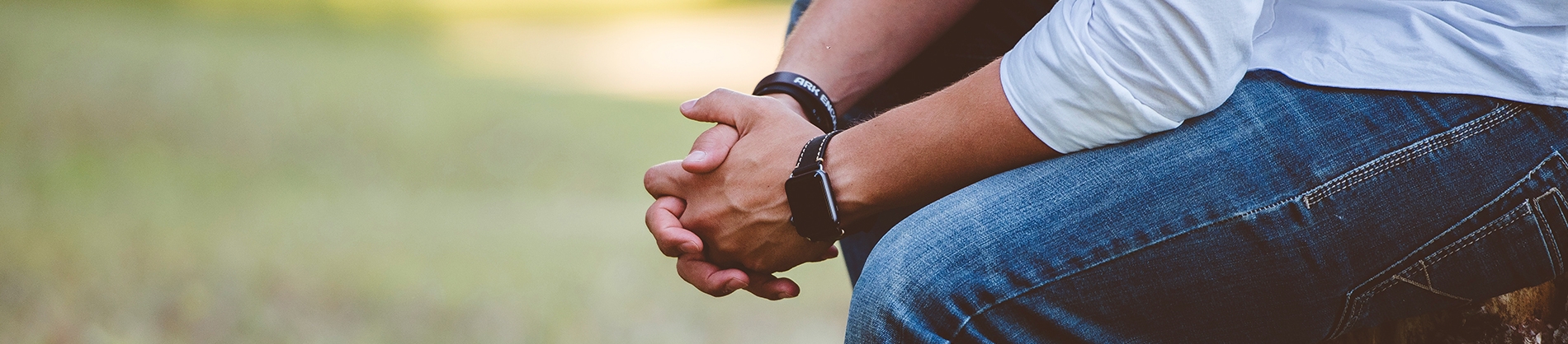 A man sat with his hands together in prayer