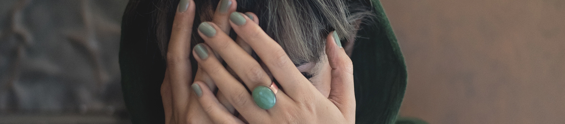 A women covering her face with her hands A women covering her face with her hands