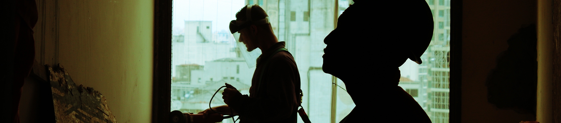 Two workmen working on a building Two workmen working on a building