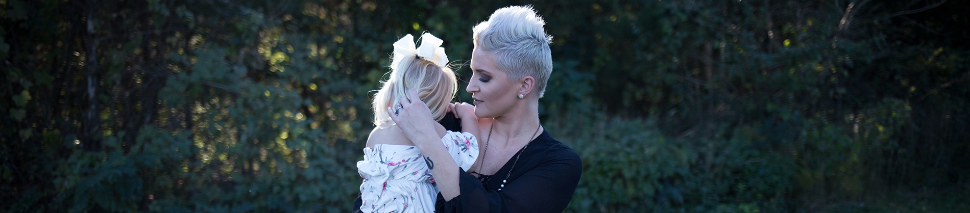 A women holding her child in a garden