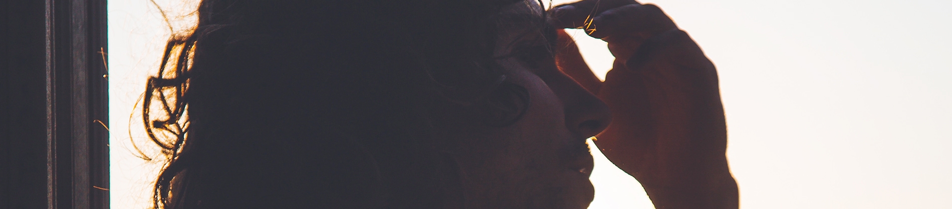A man with his hand on his forehead A man with his hand on his forehead