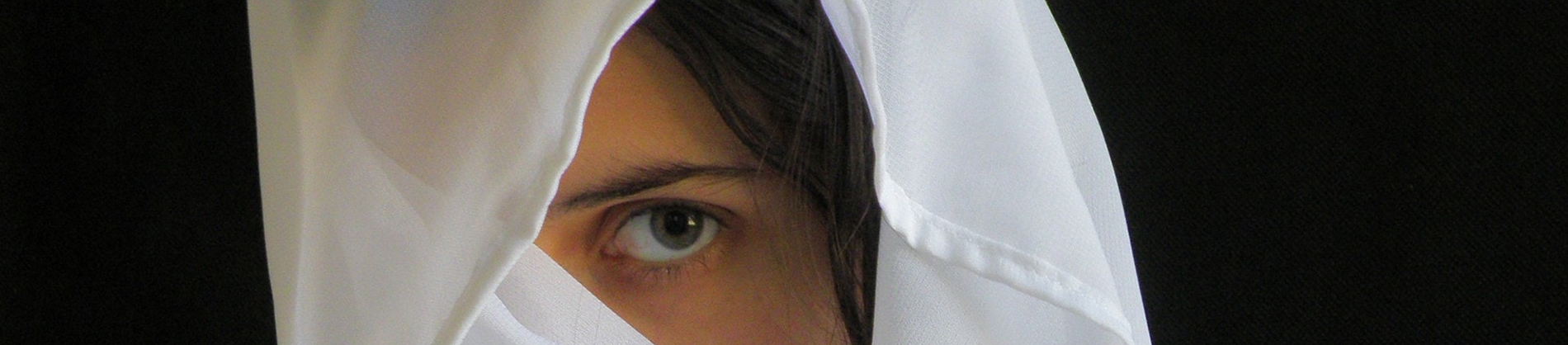 A women with white veil over her head A women with white veil over her head