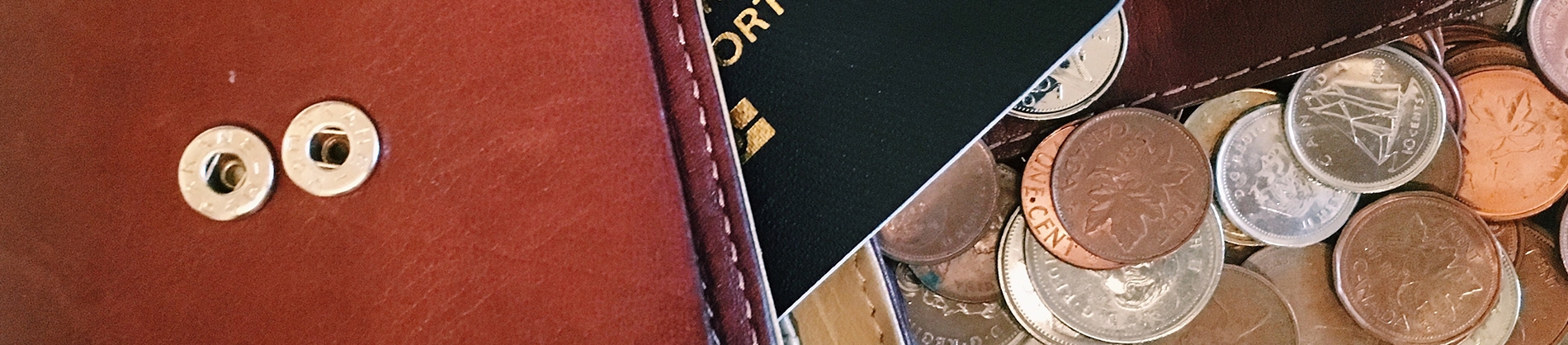 An open wallet with a debit card and coins coming out
