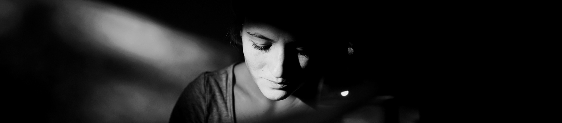 A black and white photo of a women looking down A black and white photo of a women looking down