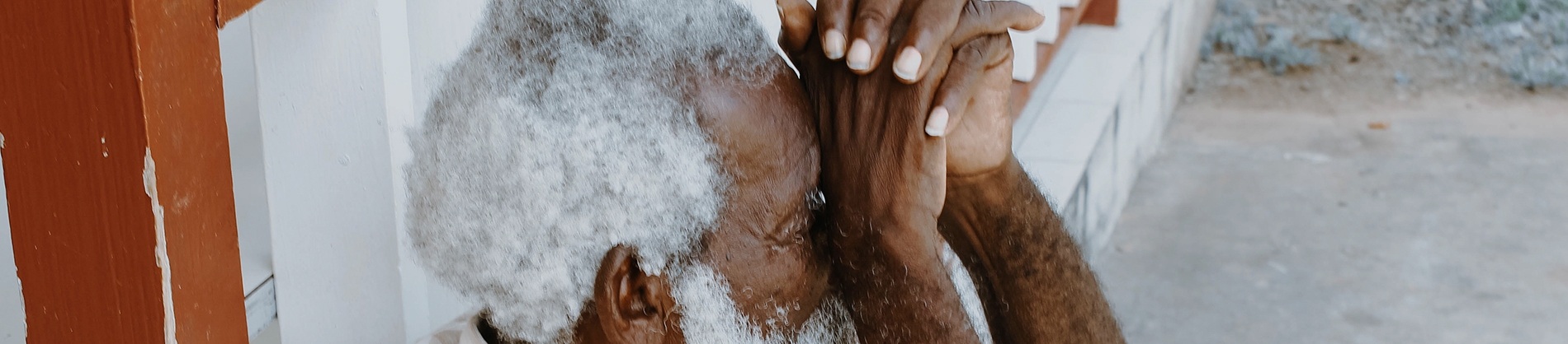 Elderly man with his hands together up to his face Elderly man with his hands together up to his face