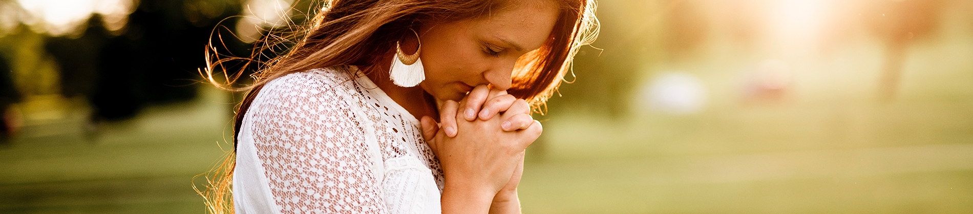 A women with her hands together praying A women with her hands together praying