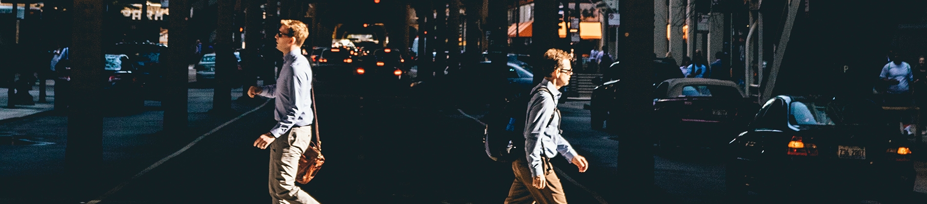 Two business men crossing the road in opposite directions Two business men crossing the road in opposite directions