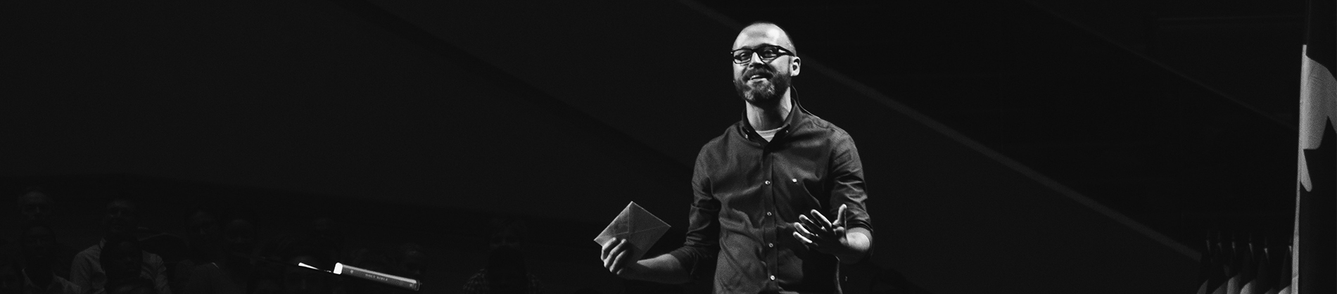 A pastor preaching on a stage A pastor preaching on a stage