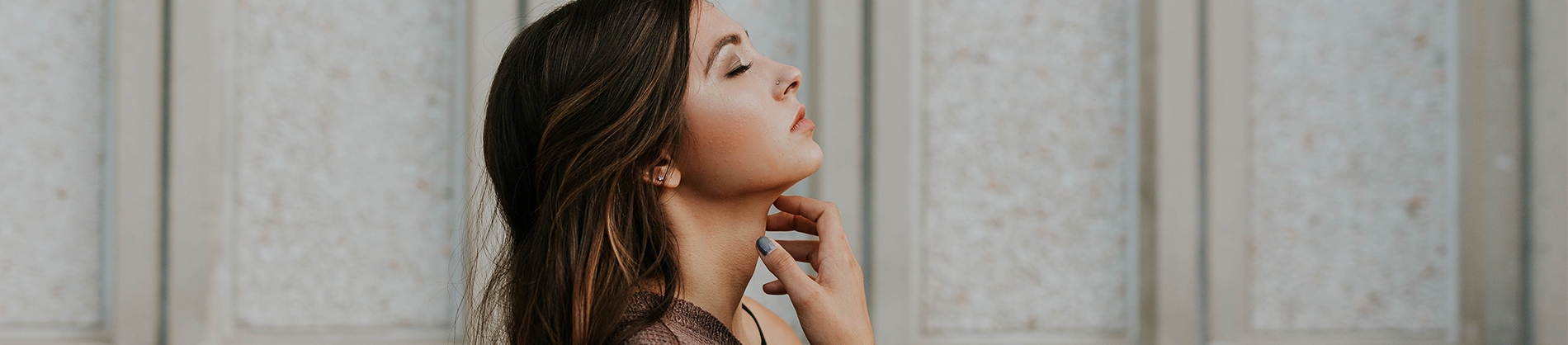 A women with her eyes closed in prayer facing the sky A women with her eyes closed in prayer facing the sky