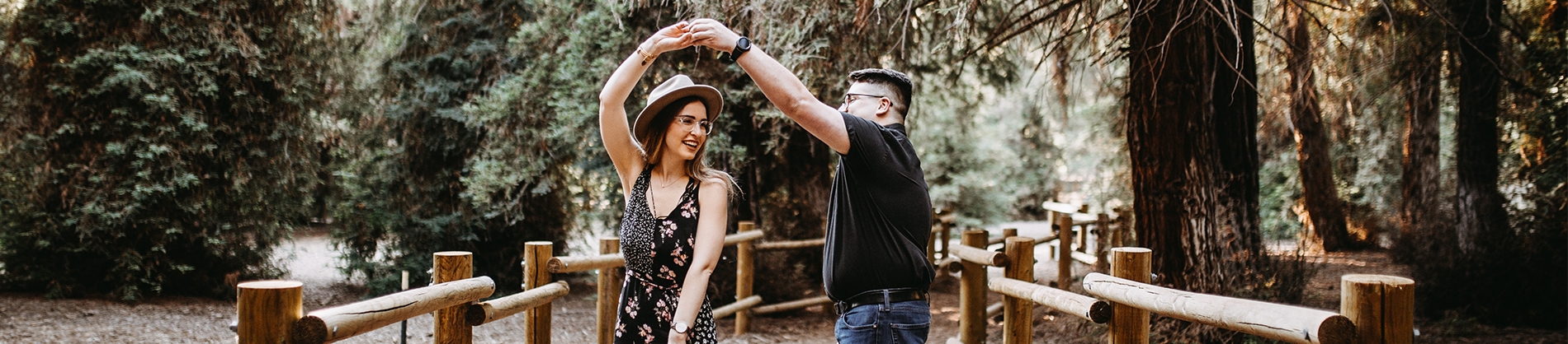 A couple dancing together on a path through a forest A couple dancing together on a path through a forest