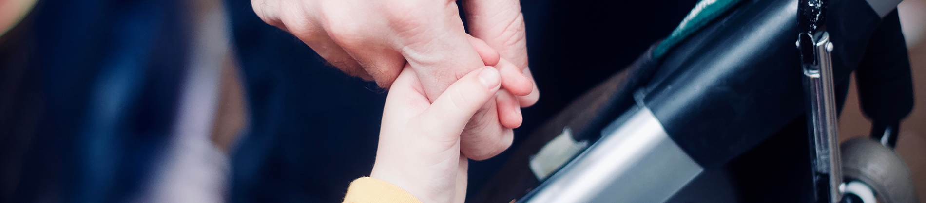 A child holding onto a parents finger A child holding onto a parents finger