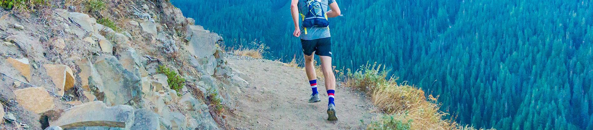 Man running up a rocking mountain