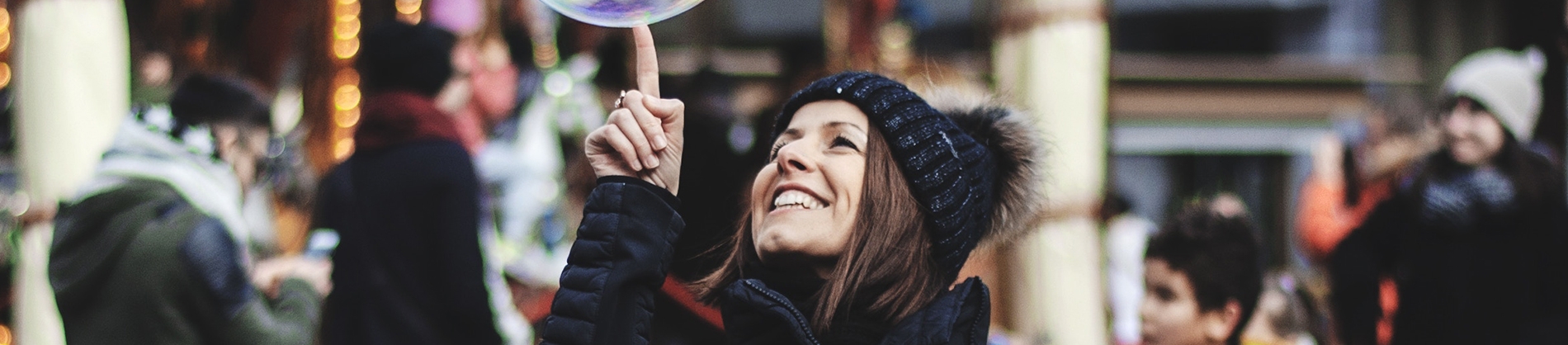 A Women dressed for winter popping a bubble A Women dressed for winter popping a bubble
