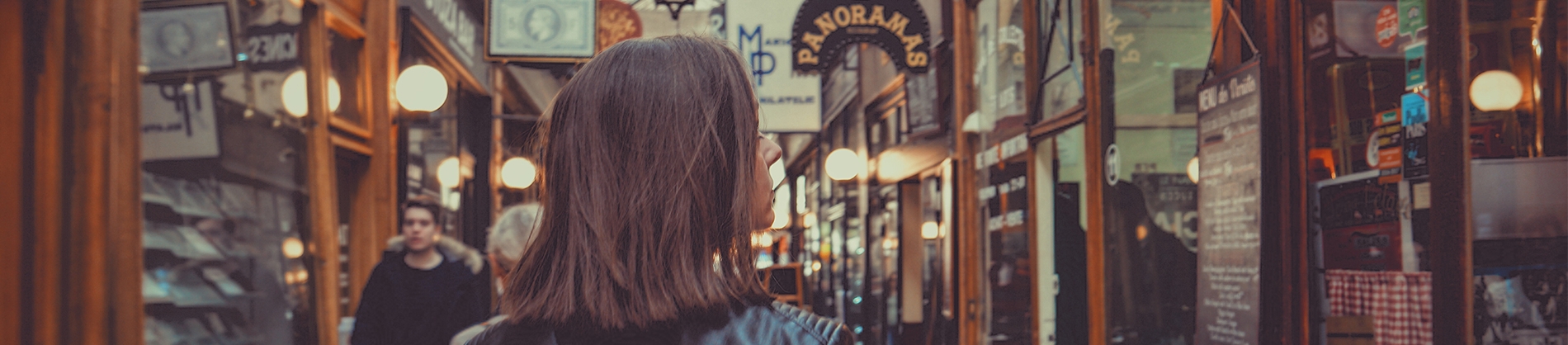 Women walking down a street of shops looking in the windows