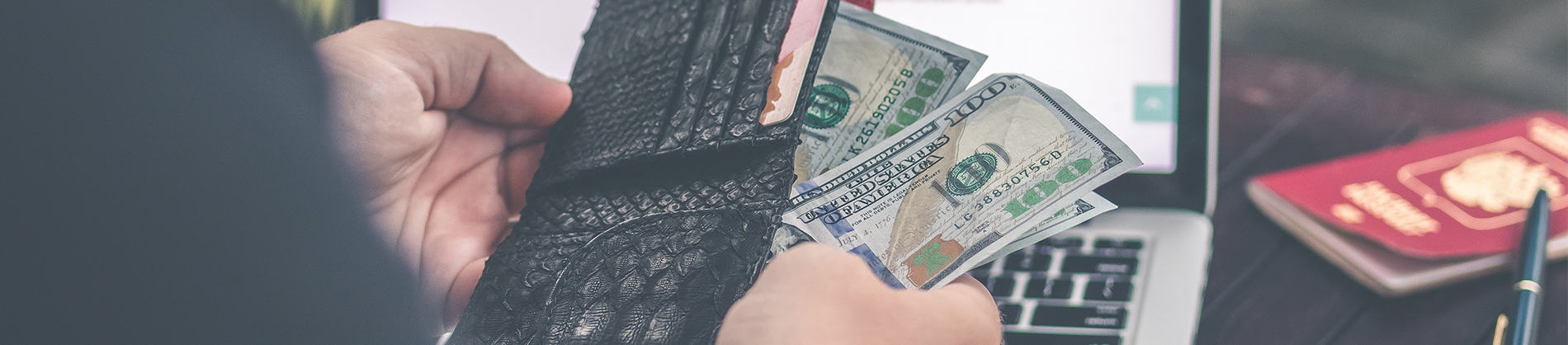 A man pulling money out of a wallet A man pulling money out of a wallet