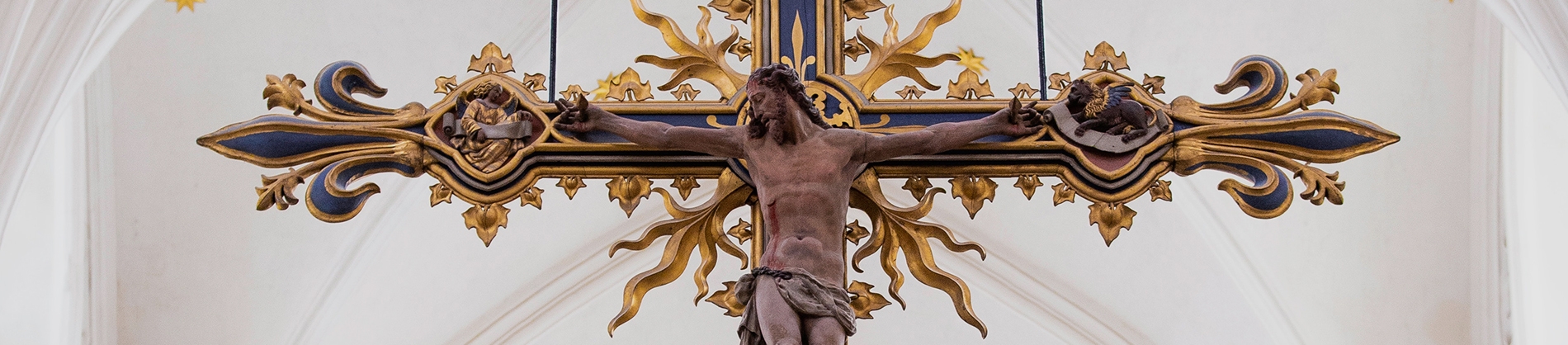 An elaborate statue of Jesus on the cross in a church An elaborate statue of Jesus on the cross in a church