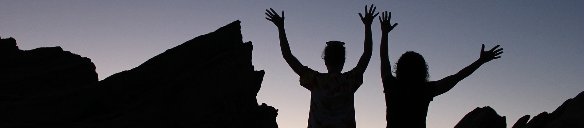 Two women with their hands up in the air Two women with their hands up in the air
