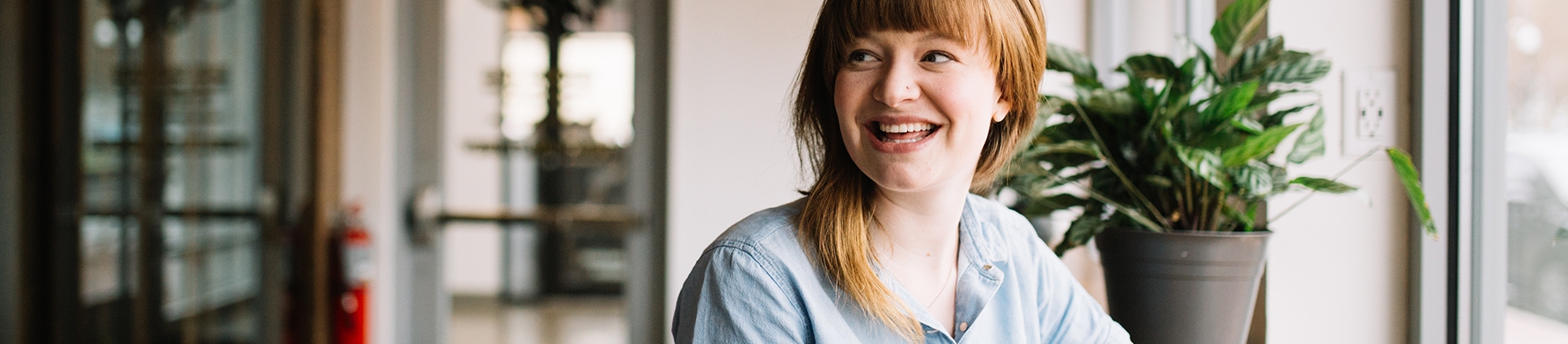 A smiling women sat by a window in a cafe A smiling women sat by a window in a cafe