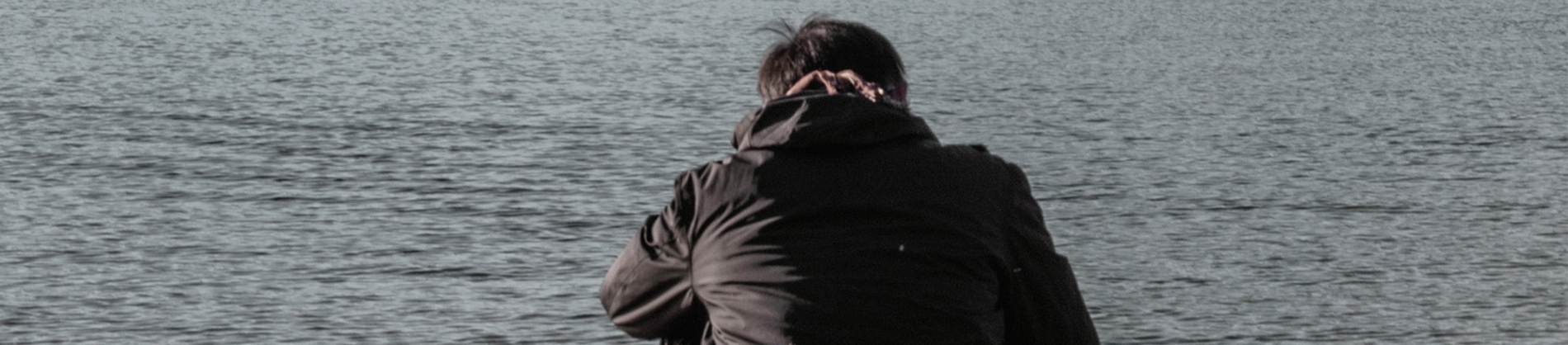 A man sat down by a lake A man sat down by a lake
