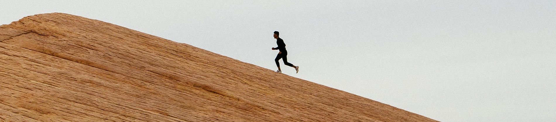 A man running up a rocky hill A man running up a rocky hill