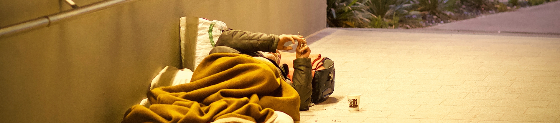 A homeless man lying on the floor in a underpass A homeless man lying on the floor in a underpass
