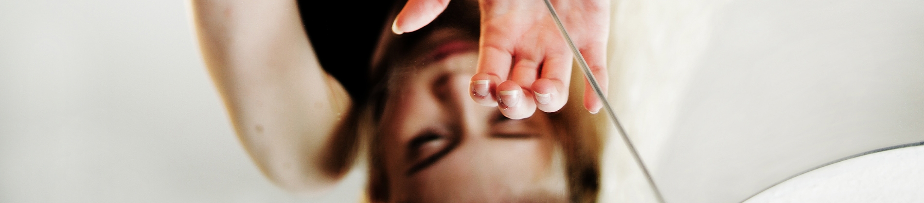 A women looking down into a glass table A women looking down into a glass table