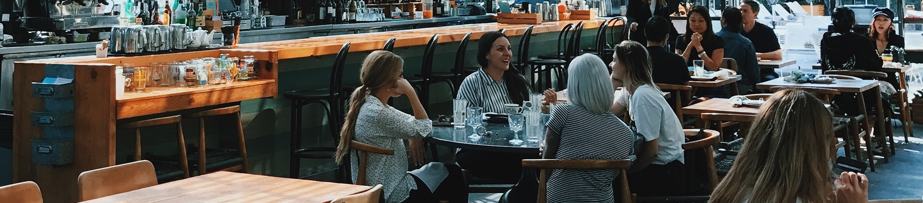 A group of women sat together in a restaurant A group of women sat together in a restaurant