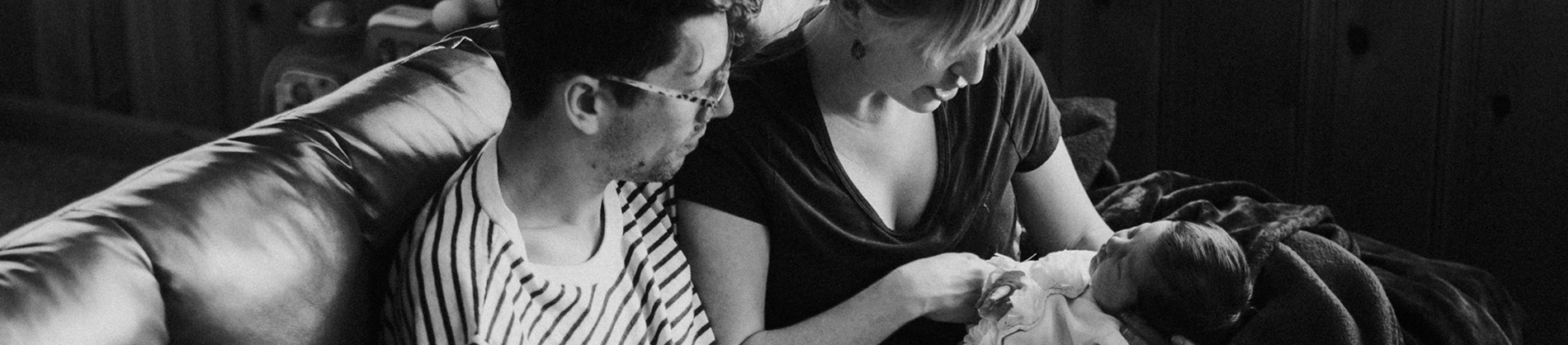 Black and White photo of parents holding their baby Black and White photo of parents holding their baby
