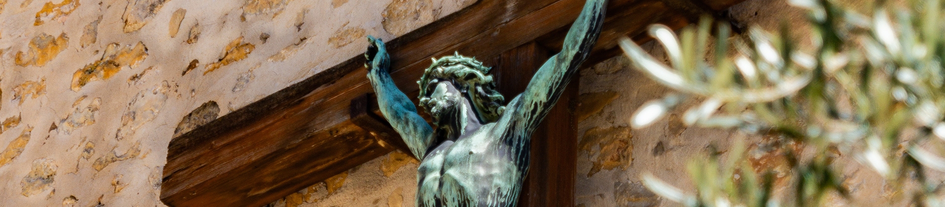 A statue of Jesus on a wooden cross A statue of Jesus on a wooden cross
