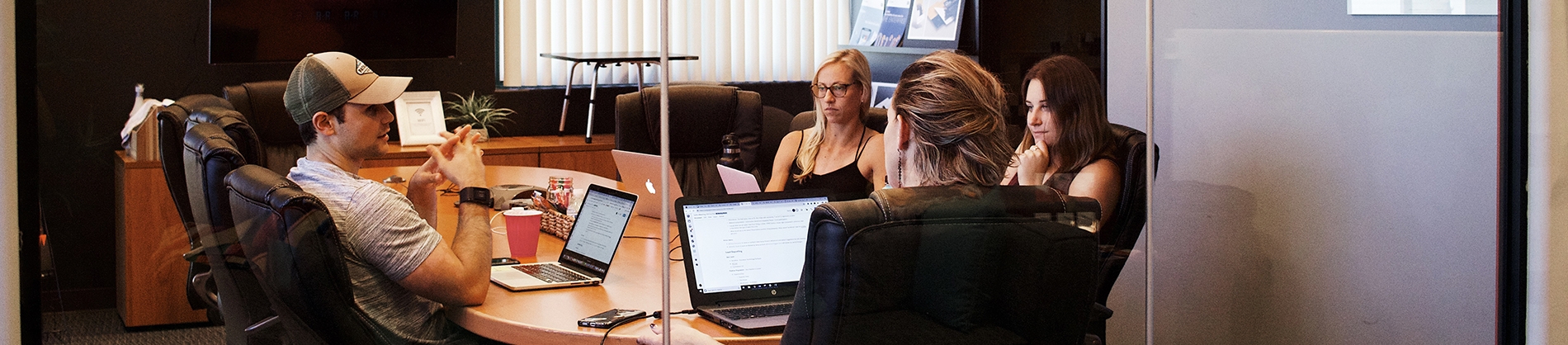Four people in a meeting room Four people in a meeting room