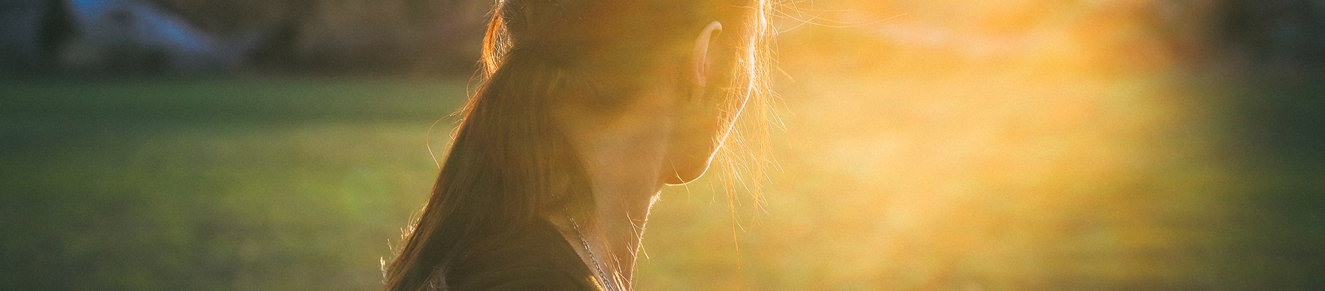 A women looking into the sun in a field
