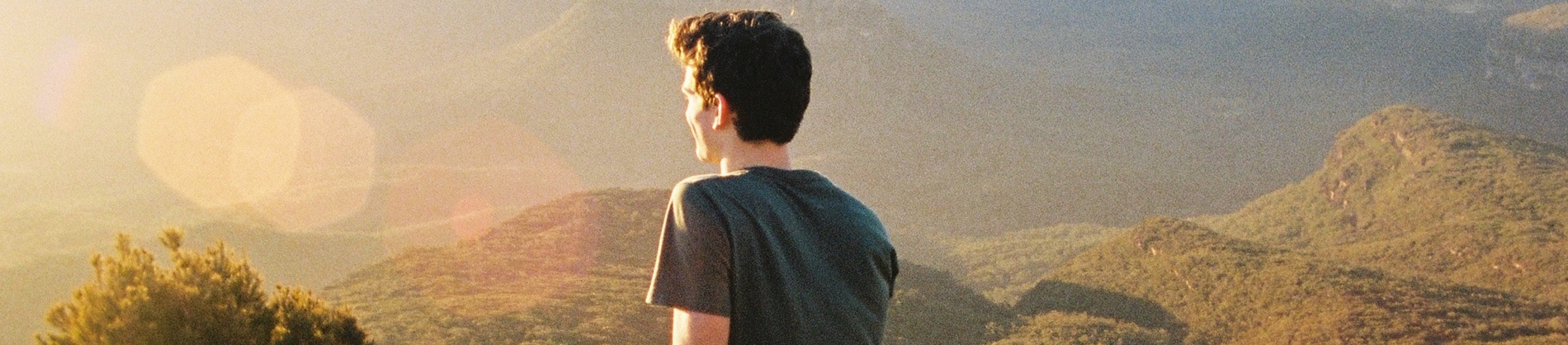 A man looking out of a landscape in the sun
