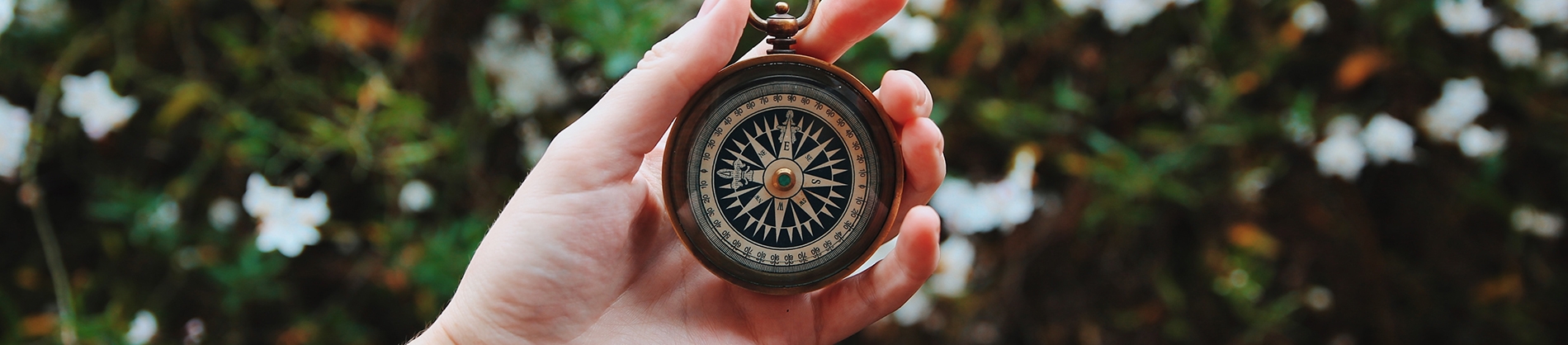 A women holding a compass up A women holding a compass up