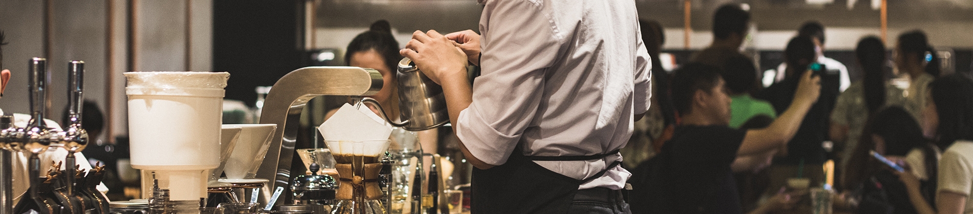 A man serving coffee in a restaurant A man serving coffee in a restaurant