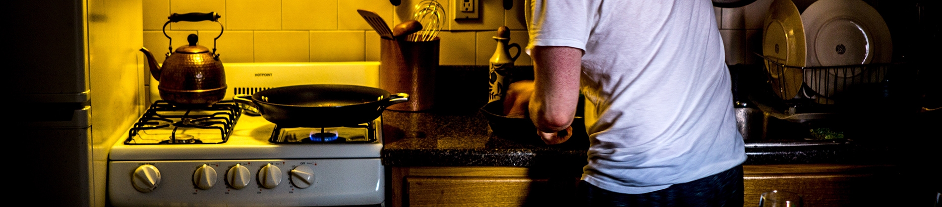 A man cooking in a small kitchen A man cooking in a small kitchen