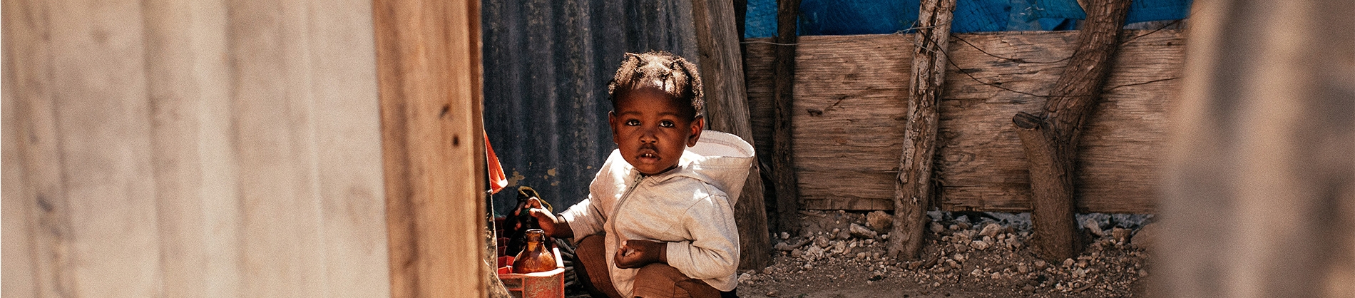 A little girl crouched on the ground