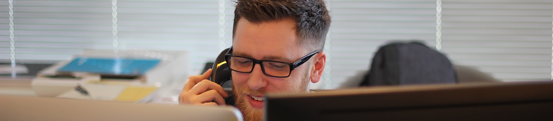 A man on the phone in a office A man on the phone in a office