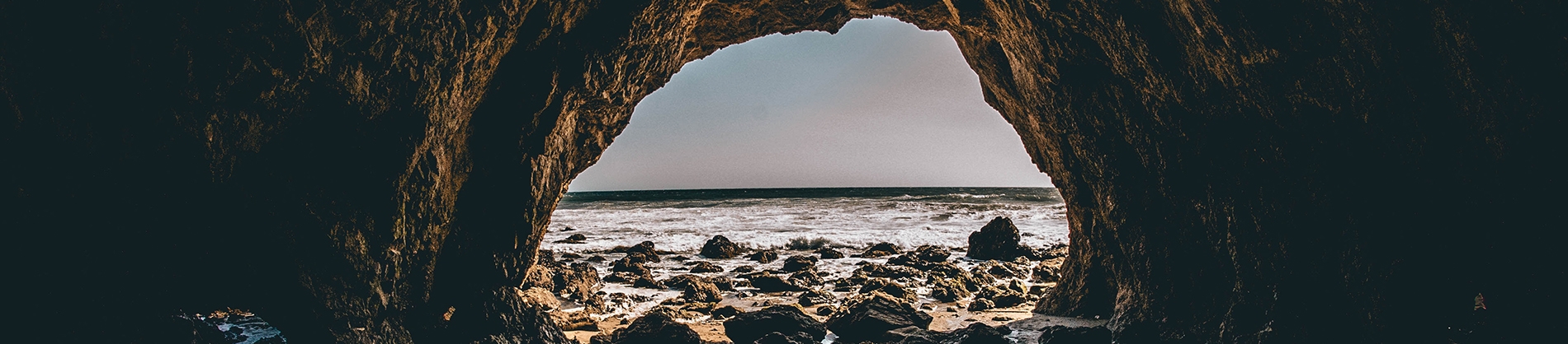 Looking out of a cave out to the sea