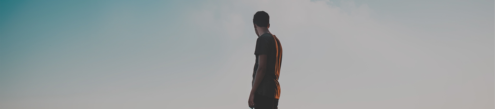 A man looking out towards a blue sky A man looking out towards a blue sky