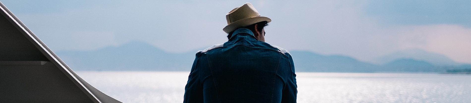 A man looking out over the ocean from a boat A man looking out over the ocean from a boat