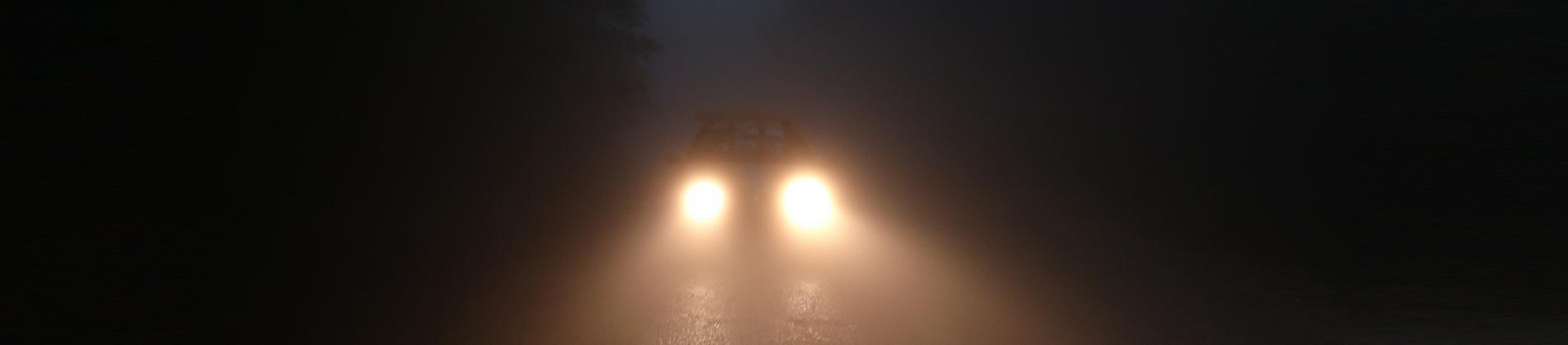 Car headlights on a dark road
